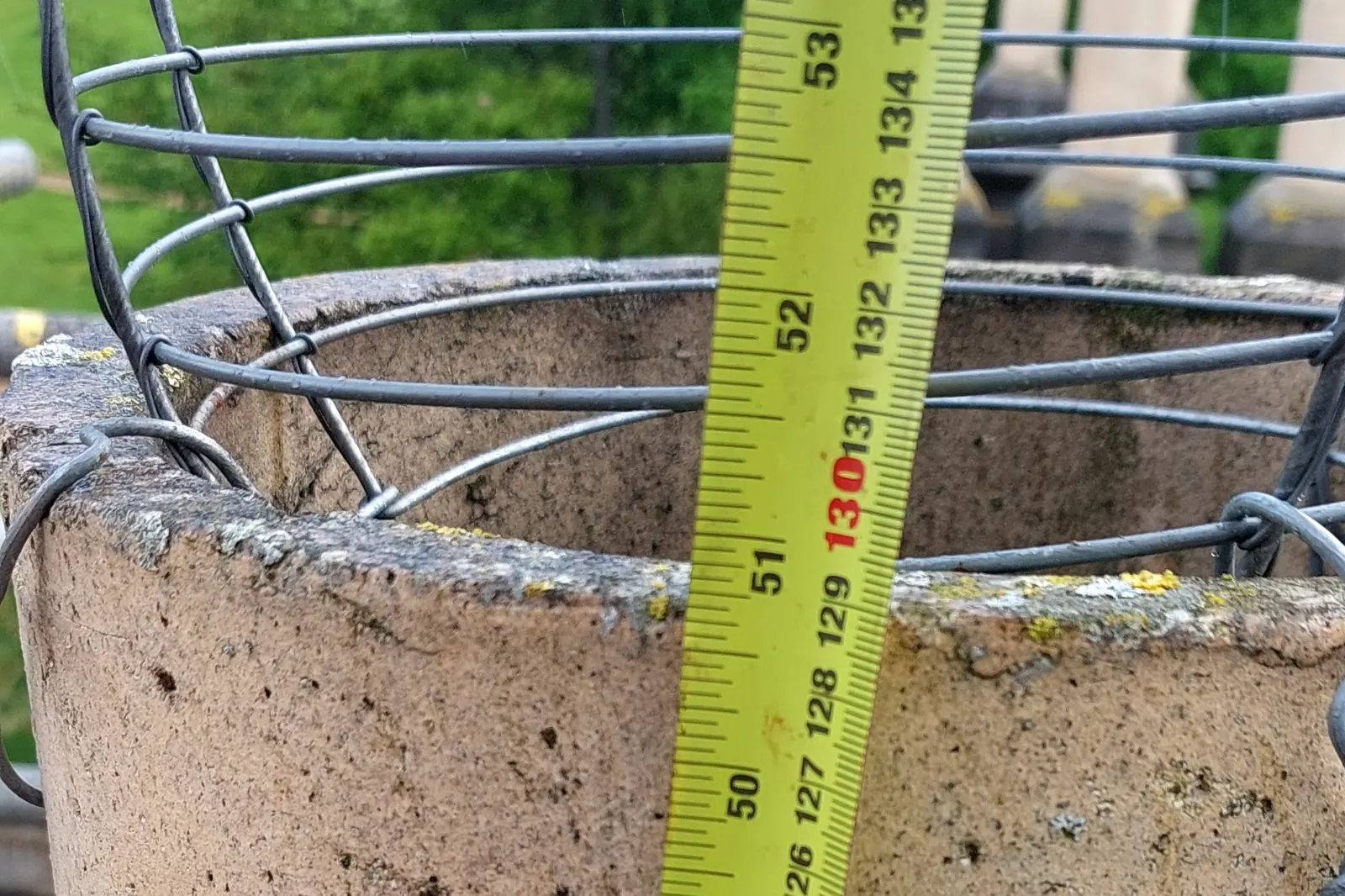 Pigeon Control in Cardiff 1 A tape measure against a chimney pot, with a cage ready to fit